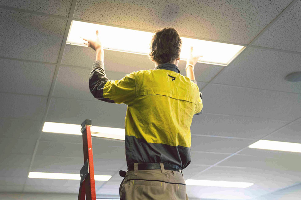 a-man-install-led-light-panel-on-the-ciling